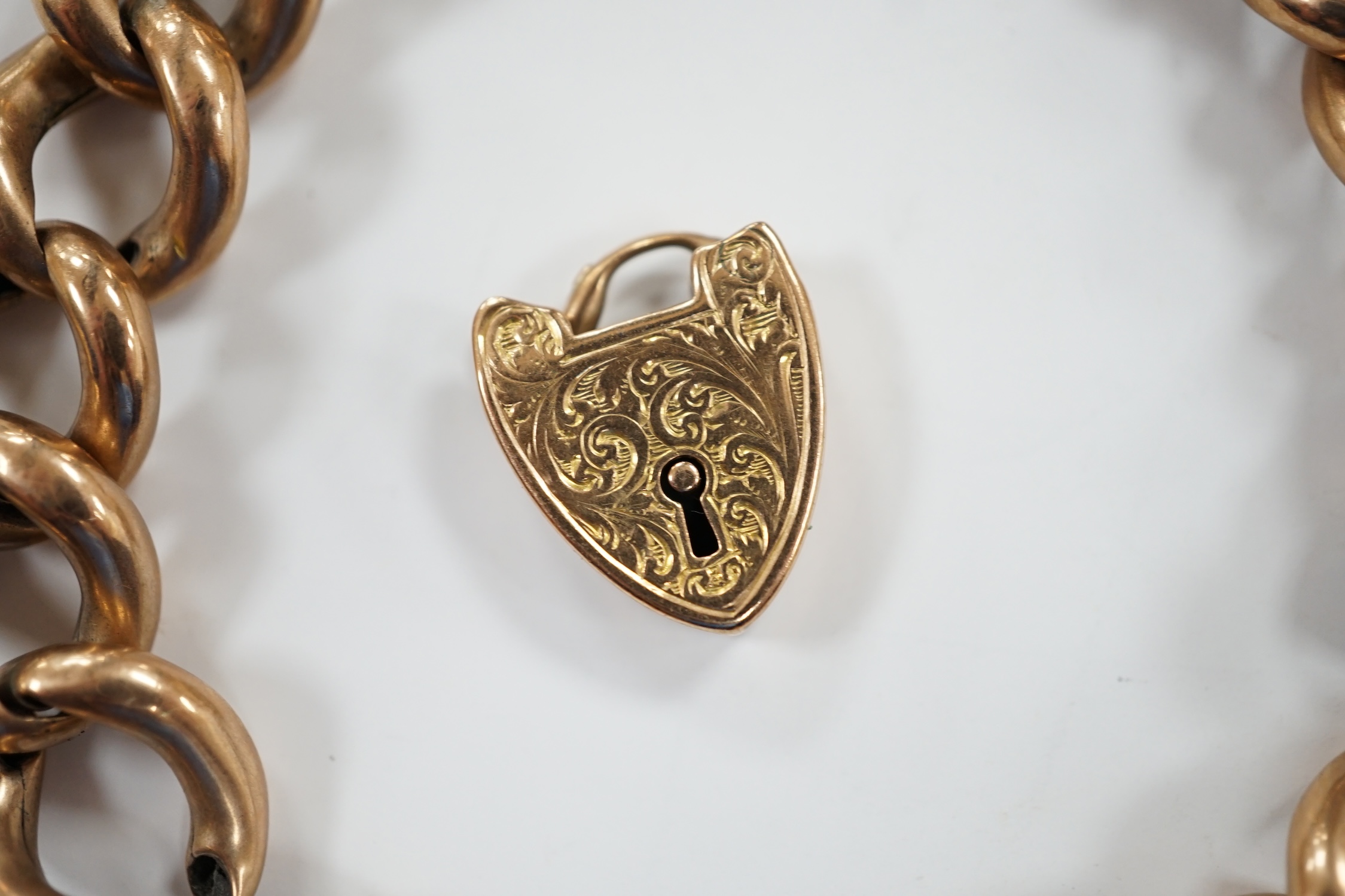 An Edwardian 9ct gold hollow curb link bracelet, with heart shaped padlock clasp(a.f.), 20cm